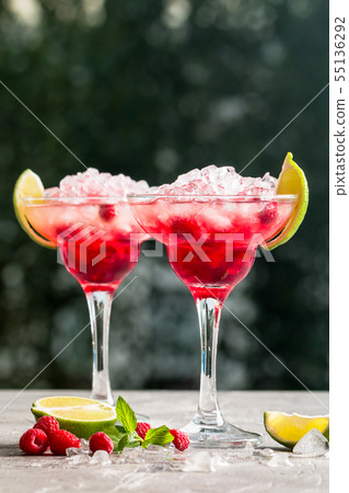 margarita cocktail with lime and raspberries margarita cocktail with lime and raspberries 55136292