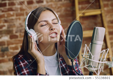 Woman recording music, broadcasting and singing at home 55136601