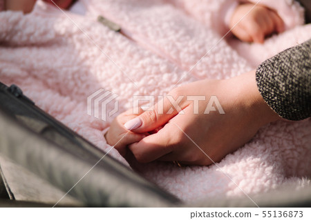 Close up of baby and mom's hands. Little newborn hand Close up of baby and mom's hands. Little newborn hand 55136873