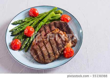 Grilled beef steak ribeye with cherry tomatoes and 55138366