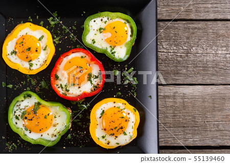 Yellow , red and green pepper with fried eggs Yellow , red and green pepper with fried eggs 55139460