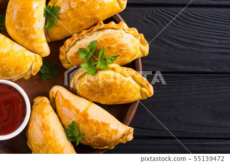 Latin American baked beef empanadas with sauce Latin American baked beef empanadas with sauce 55139472