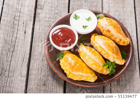 Latin American baked beef empanadas with sauce Latin American baked beef empanadas with sauce 55139477