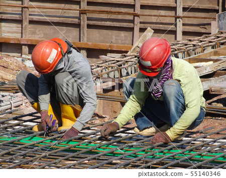 Workers fabricating steel reinforcement bar 55140346