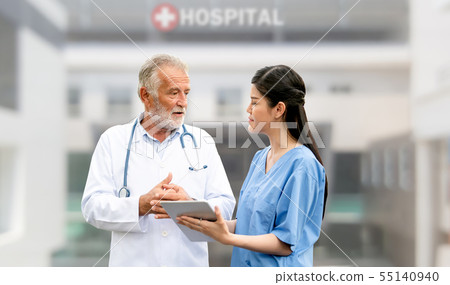Senior and young doctor working in the hospital. Senior and young doctor working in the hospital. 55140940
