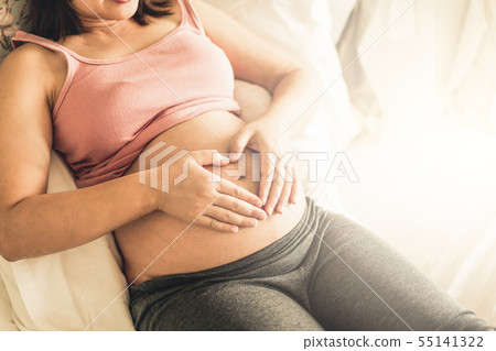 Happy pregnant woman and expecting baby at home. 55141322