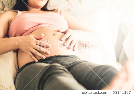 Happy pregnant woman and expecting baby at home. 55141397