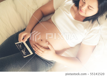Happy pregnant woman and expecting baby at home. 55141520
