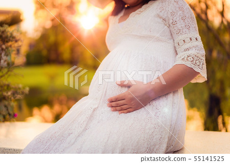 Pregnant woman feeling happy at garden home. 55141525