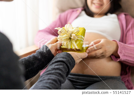 Pregnant couple feels love and relax at home. Pregnant couple feels love and relax at home. 55141527