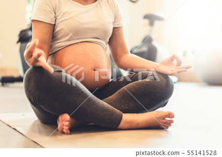 Active pregnant woman exercise in fitness center. Active pregnant woman exercise in fitness center. 55141528