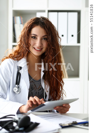 Beautiful smiling female doctor hold tablet pc 55141816