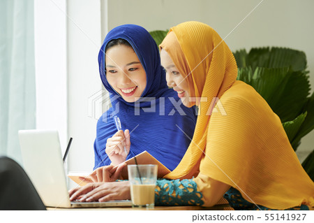 Young muslim women watching lection online Young muslim women watching lection online 55141927