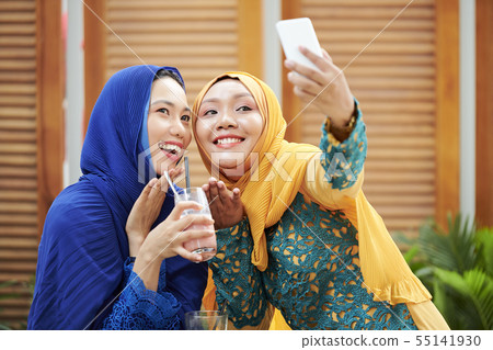Young women in hijabs posing for selfie 55141930