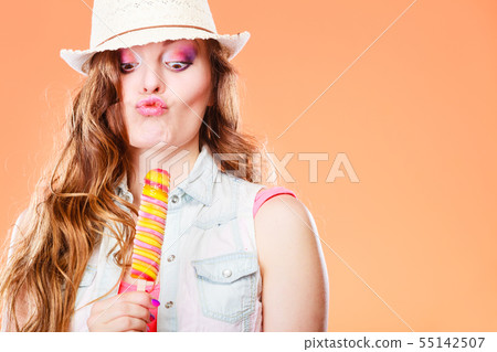 woman in summer hat eating ice pop cream woman in summer hat eating ice pop cream 55142507