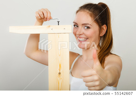 Success ful woman assembling furniture. DIY. 55142607