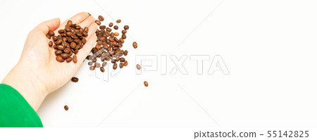 Dark roasted coffee beens in the farmer s hand 55142825