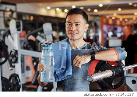 Portrait of sportsman with towel and water bottle 55143137
