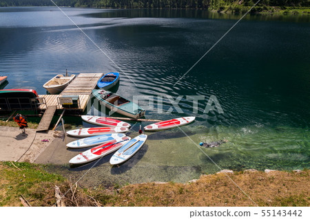 Paddle surf lying on surface of Vorderer Gosausee Paddle surf lying on surface of Vorderer Gosausee 55143442
