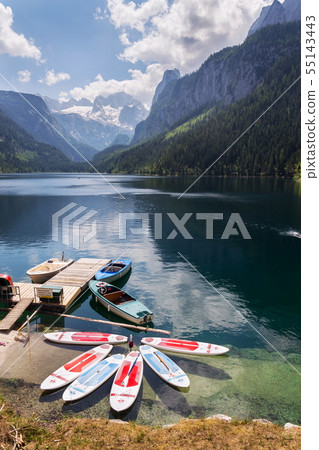 Paddle surf lying on surface of Vorderer Gosausee Paddle surf lying on surface of Vorderer Gosausee 55143443