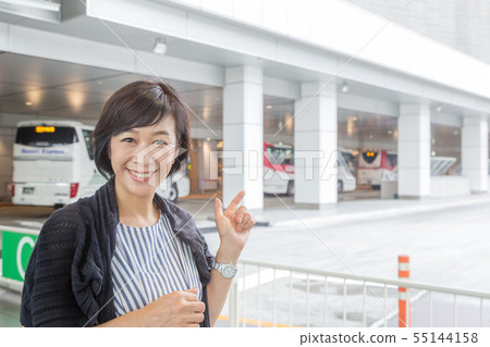 Bus trip Woman looking at timetable. Middle woman going to hot spring place from busta Shinjuku Bus trip Woman looking at timetable. Middle woman going to hot spring place from busta Shinjuku 55144158
