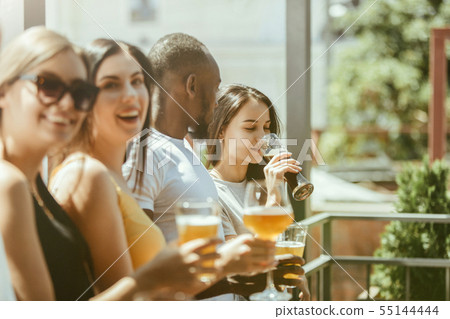 Young group of friends drinking beer and celebrating together 55144444