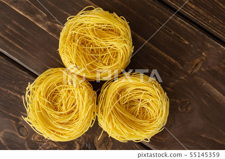 Angel hair pasta on brown wood 55145359
