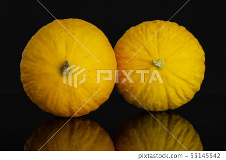 Yellow canary melon isolated on black glass Yellow canary melon isolated on black glass 55145542