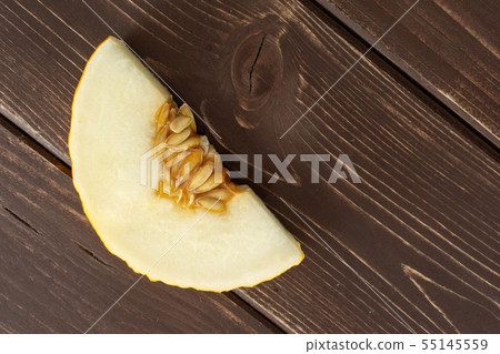 Yellow canary melon on brown wood Yellow canary melon on brown wood 55145559