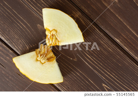 Yellow canary melon on brown wood Yellow canary melon on brown wood 55145565