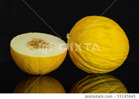 Yellow canary melon isolated on black glass 55145645