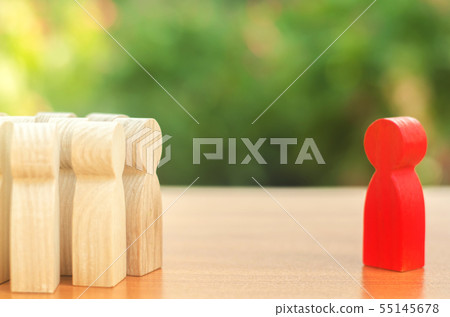 Red figurine of a man stands aside from the crowd 55145678