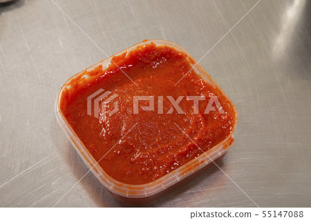 A red hot sauce made of roasted bell peppers. A red hot sauce made of roasted bell peppers. 55147088