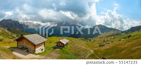 Odle Puez mountain and wooden chalets in Dolomites, Trentino Alto Adige, Italy Odle Puez mountain and wooden chalets in Dolomites, Trentino Alto Adige, Italy 55147235