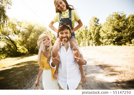 Family walk. Parents play with his daughters outdoors 55147250