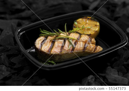 Close up of fresh cooked fish with rosemary in box Close up of fresh cooked fish with rosemary in box 55147373