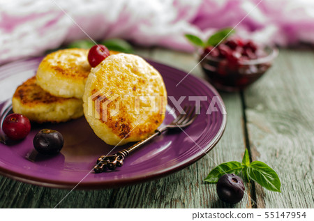 Cottage cheese pancakes on a dark background. Syrniki with fresh mint. Pancakes with cottage cheese Cottage cheese pancakes on a dark background. Syrniki with fresh mint. Pancakes with cottage cheese 55147954