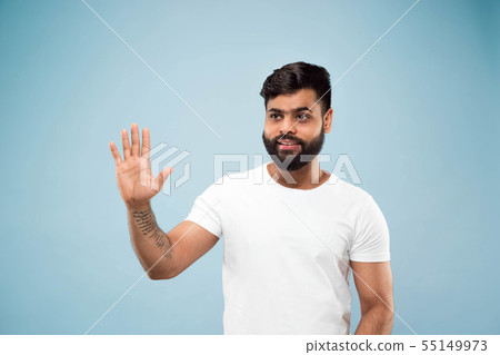 Half-length close up portrait of young man on blue background. 55149973