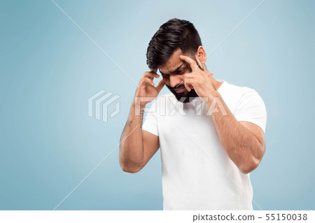 Half-length close up portrait of young man on blue background. 55150038