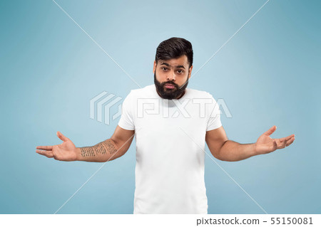 Half-length close up portrait of young man on blue background. Half-length close up portrait of young man on blue background. 55150081
