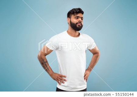Half-length close up portrait of young man on blue background. Half-length close up portrait of young man on blue background. 55150144