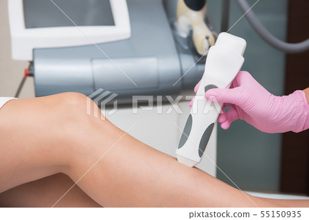 Specialist makes skin tone measurements on a womans leg Specialist makes skin tone measurements on a womans leg 55150935