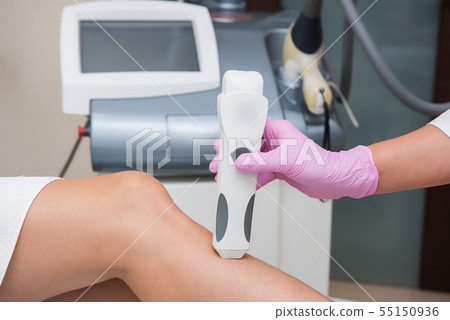 Specialist makes skin tone measurements on a womans leg Specialist makes skin tone measurements on a womans leg 55150936