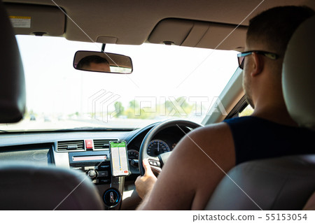 male driving a car on the road using a new, concept of traveling by car, gps. 55153054