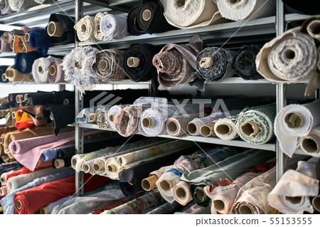 Fabric warehouse with many multicolored textile rolls Fabric warehouse with many multicolored textile rolls 55153555
