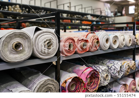 Fabric warehouse with many multicolored textile rolls 55155474