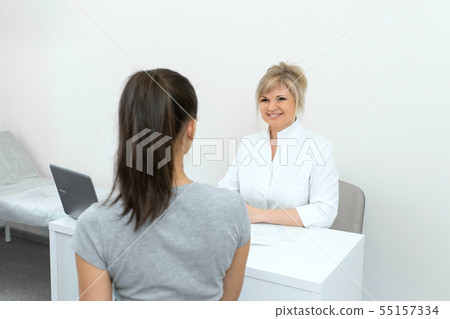 Beautiful woman gynecologist is conducting a Beautiful woman gynecologist is conducting a 55157334