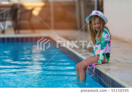 Portrait of cute happy little girl having fun in swimming pool Portrait of cute happy little girl having fun in swimming pool 55158595