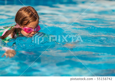 little girl swimming glasses in swimming pool 55158742