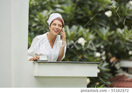 Beautiful woman talking on phone in morning Beautiful woman talking on phone in morning 55162872